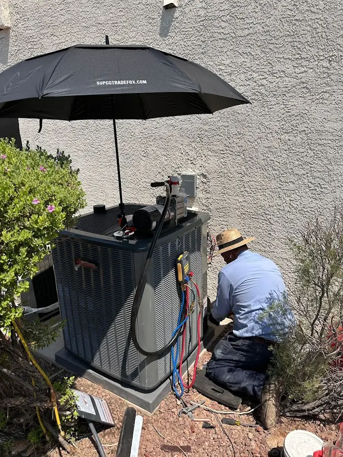 HVAC technician performing outdoor AC maintenance in Turpin Hills