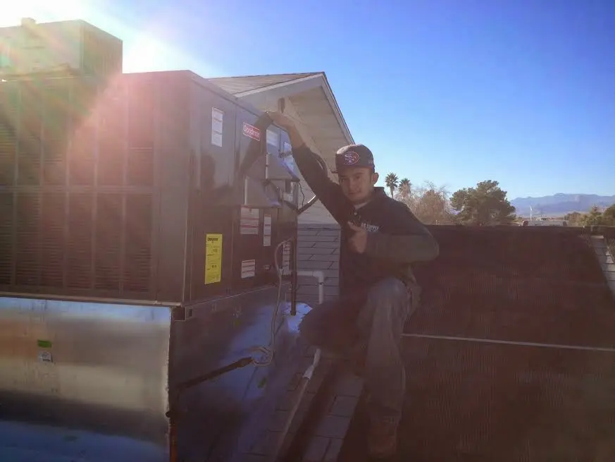 HVAC technician performing HVAC Inspection on a rooftop unit in Turpin Hills